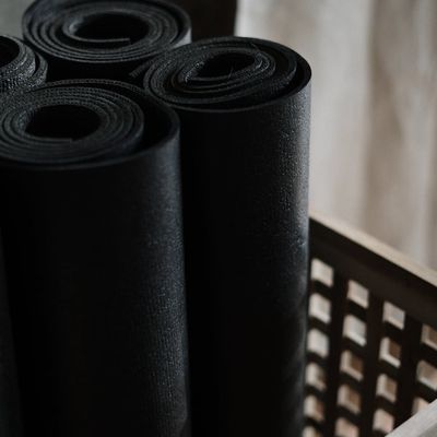 Close up of a blue yoga mat and wooden blocks