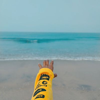 Hand reaching towards the sky in a stretching movement