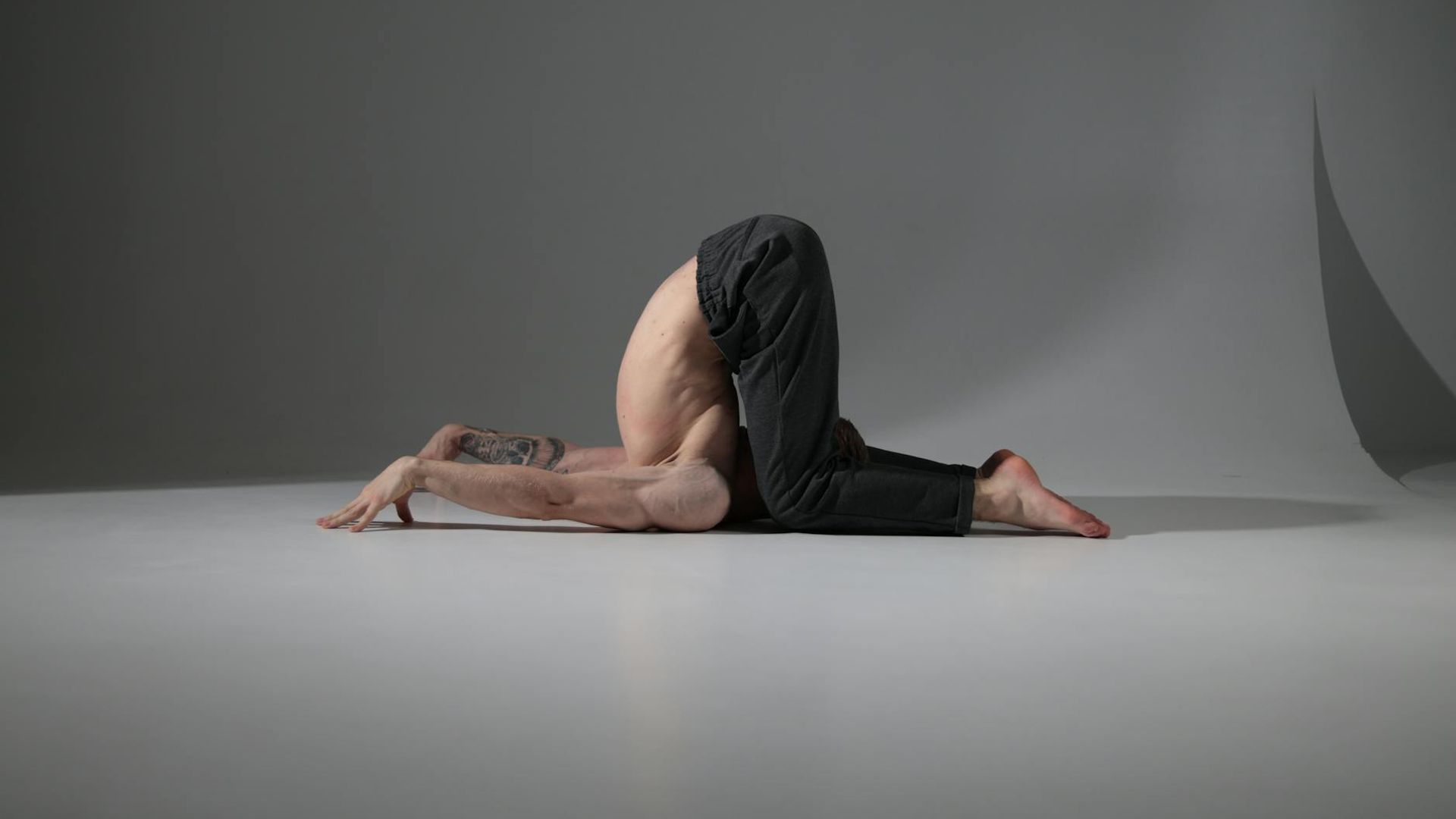 Serene yoga practitioner in a bright minimalist studio space